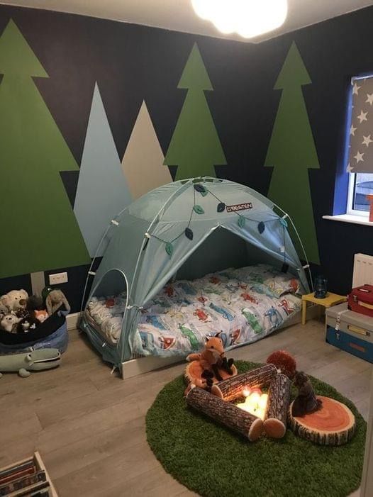 a child's bedroom with a tent and fire pit