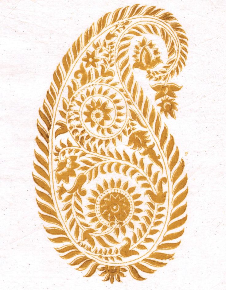 an intricately designed golden paisley on white paper