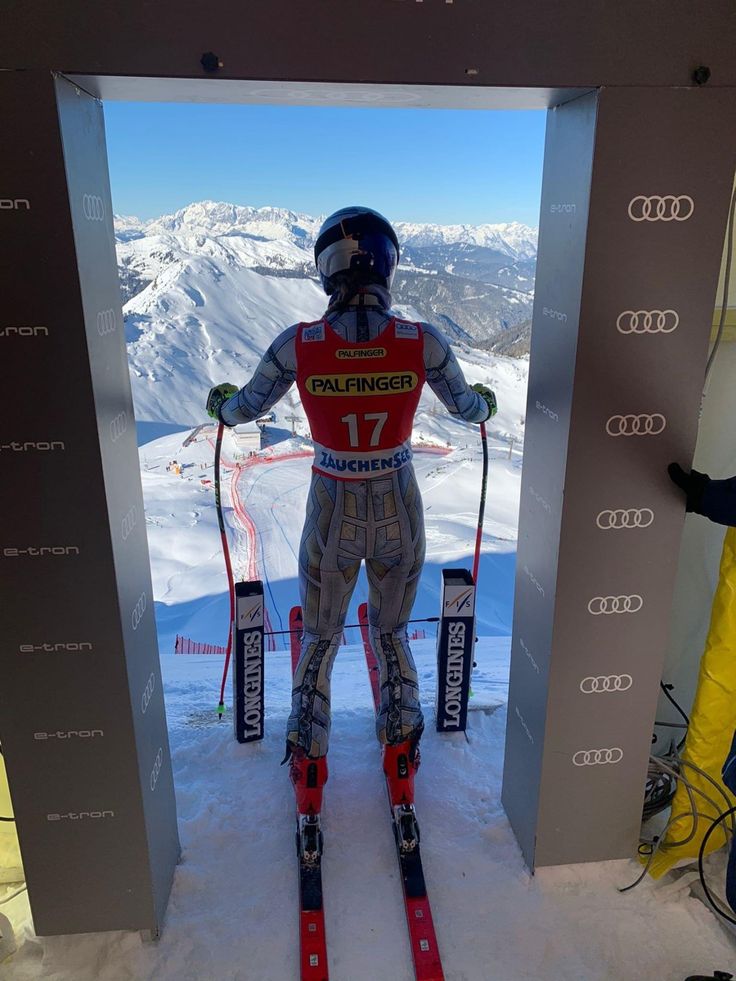 a man on skis standing in front of an open door