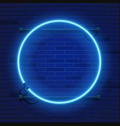 a blue neon circle on a brick wall