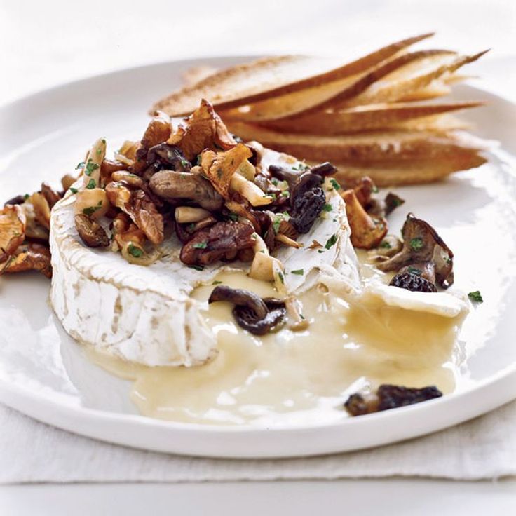 a white plate topped with mashed potatoes and mushrooms