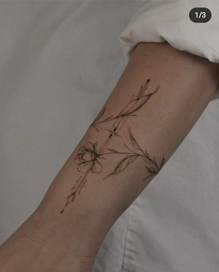 a woman's arm with a flower tattoo on it