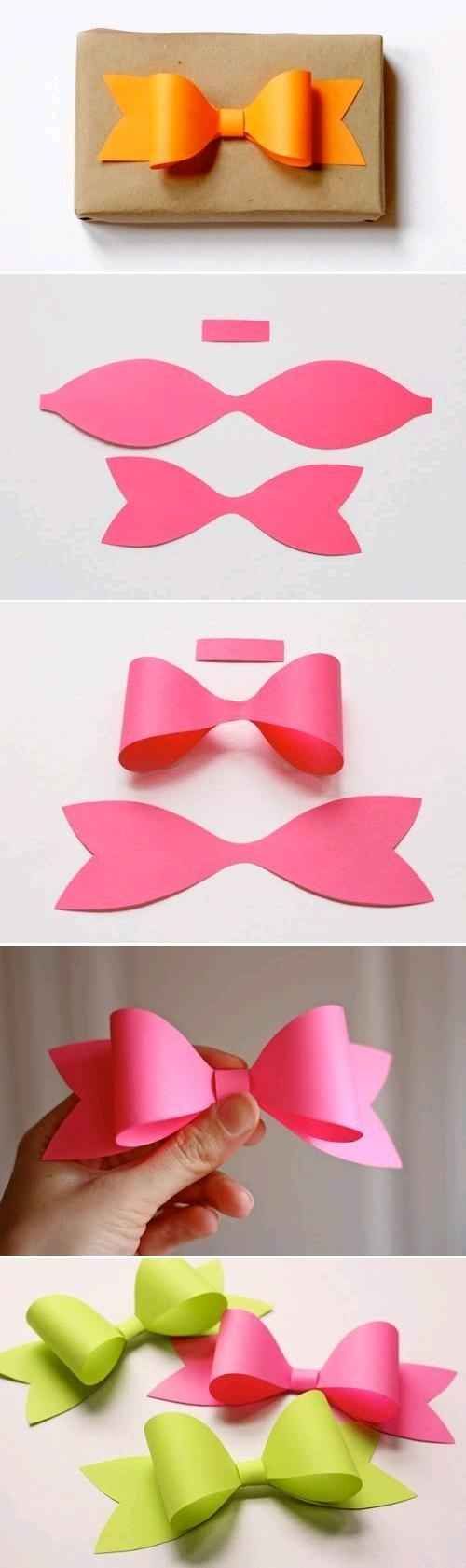 some pink and yellow paper bows are being cut out