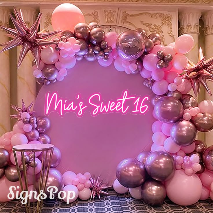 a pink and silver balloon arch with stars on it that says, miss sweet 16