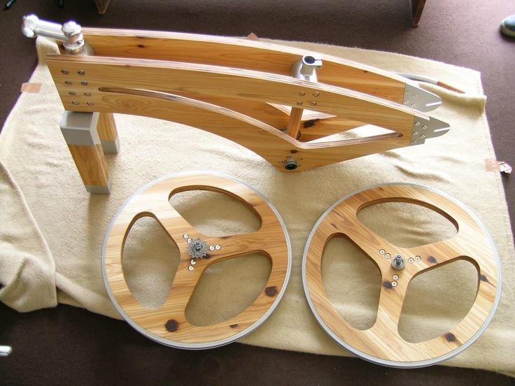 two wooden wheels are sitting next to each other on a piece of cloth and some scissors