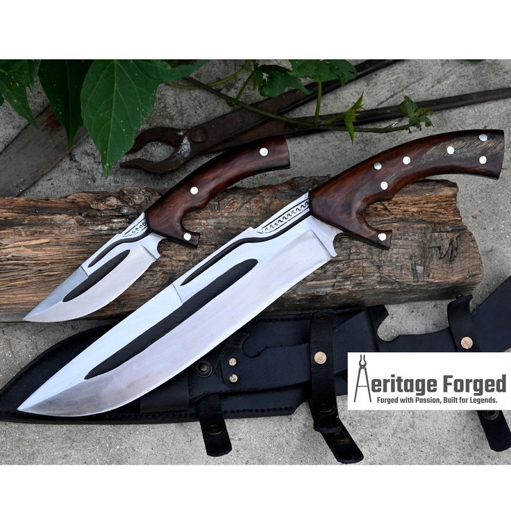 three knives are sitting next to each other on a piece of wood with the words heritage folded below it