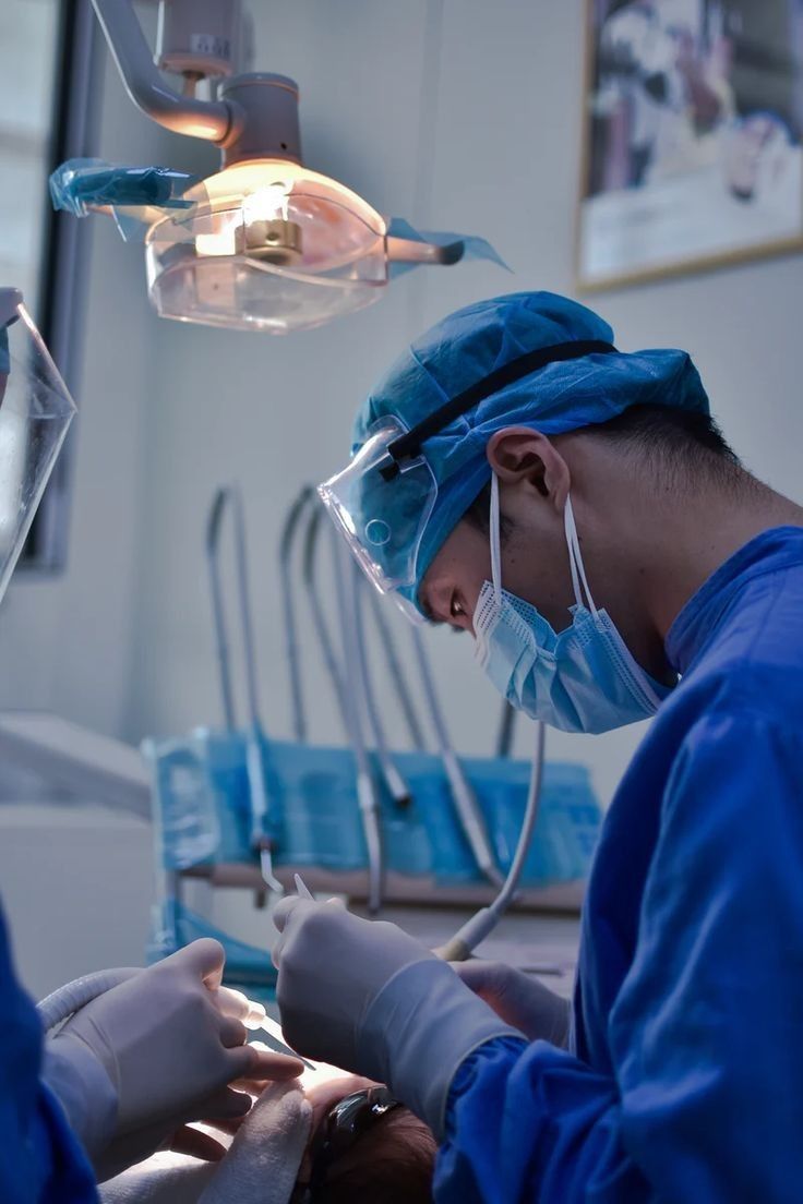 two surgeons performing surgery on a patient in an operating room