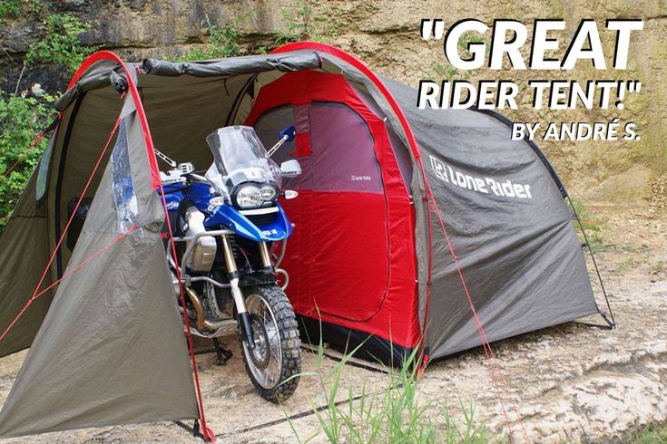 a motorcycle parked in front of a tent with the words great rider tent written on it