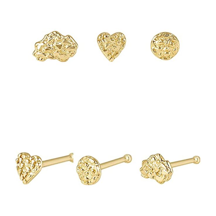 three pairs of gold heart shaped studs and two hearts on each ear, one in the