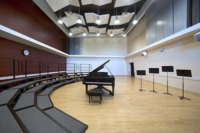 an empty concert hall with piano and musical instruments