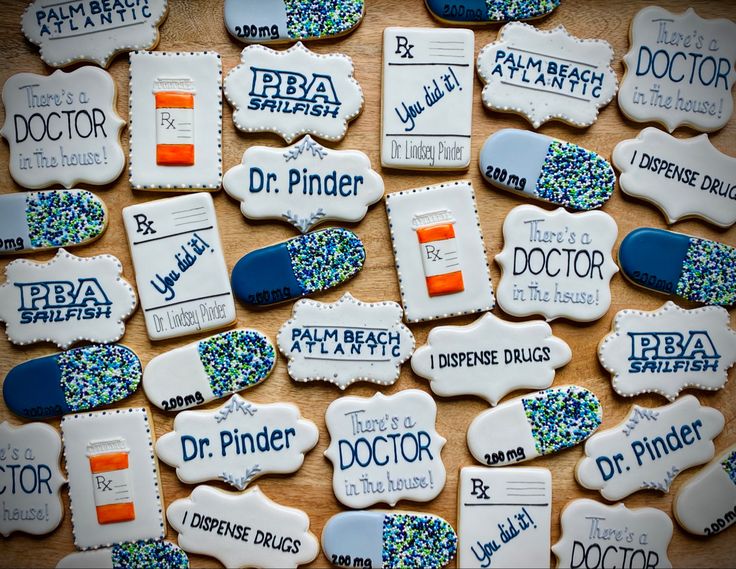 decorated cookies with the words dr pinder and doctor written in blue, orange and white