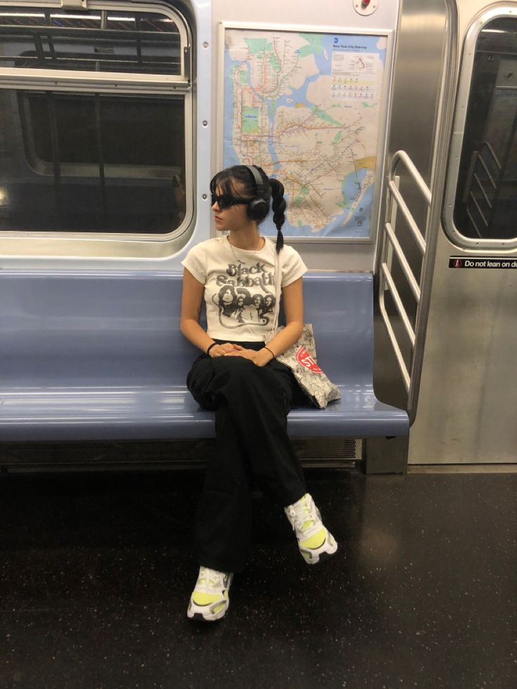 a woman sitting on a subway train seat