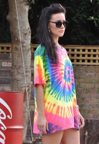 a woman in a tie - dyed dress and sunglasses