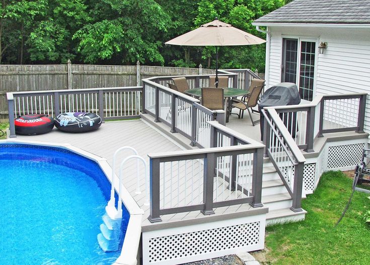 an above ground pool with deck and hot tub