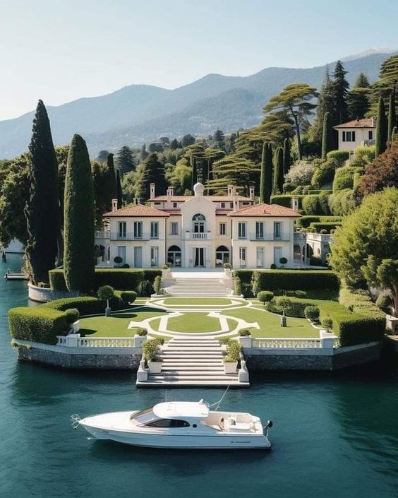 a boat is in the water near a mansion