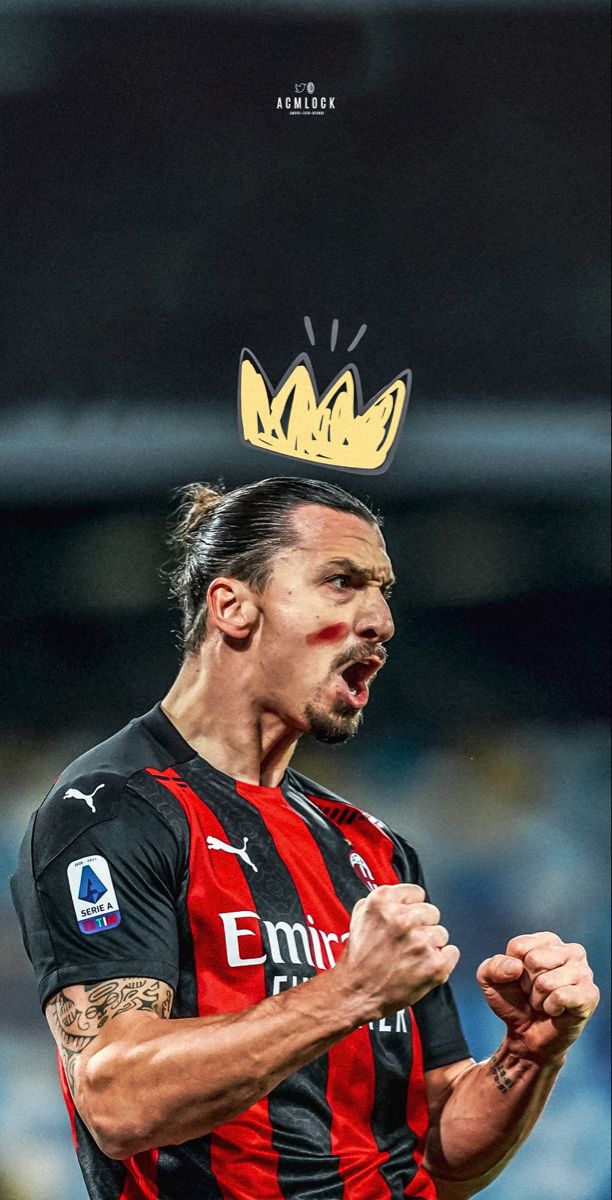 a man with a crown on top of his head in the middle of a soccer field