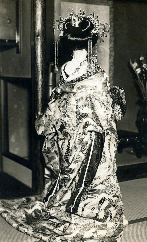 an old photo of a woman in a costume