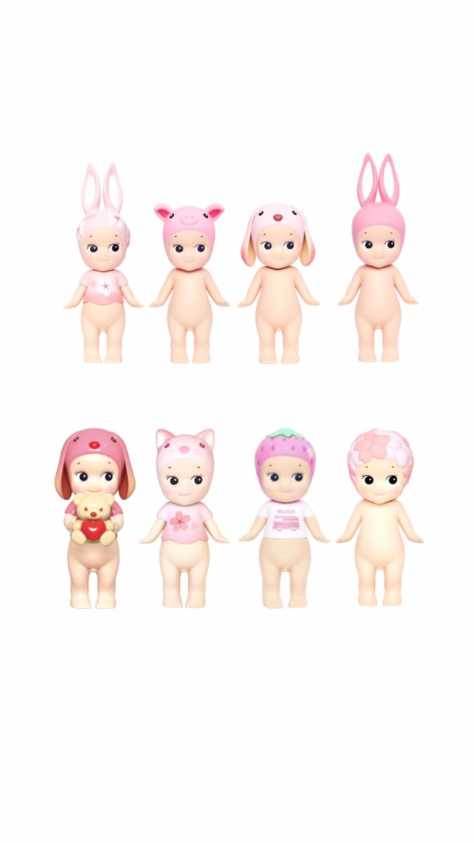 a group of small toy animals with pink hair and bunny ears on their heads, standing next to each other