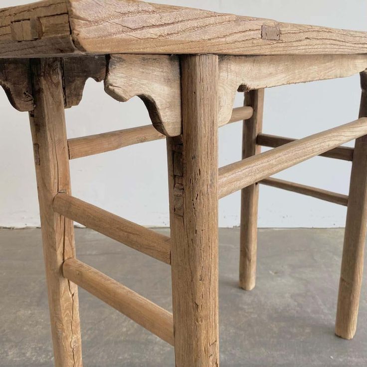 an old wooden table that has been turned into a bench for someone to sit on