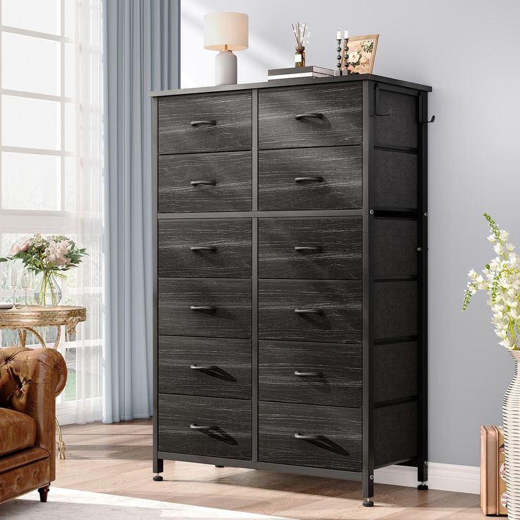 a black dresser with drawers in a living room