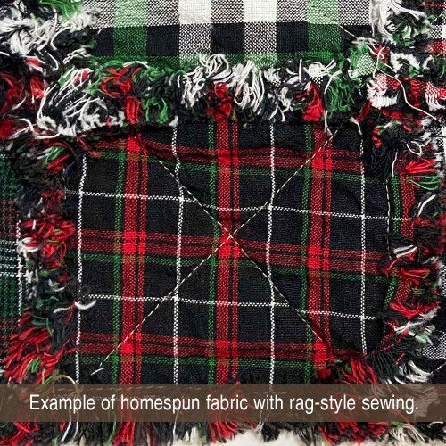 an image of a plaid fabric with fringes on the bottom and green, white and red colors