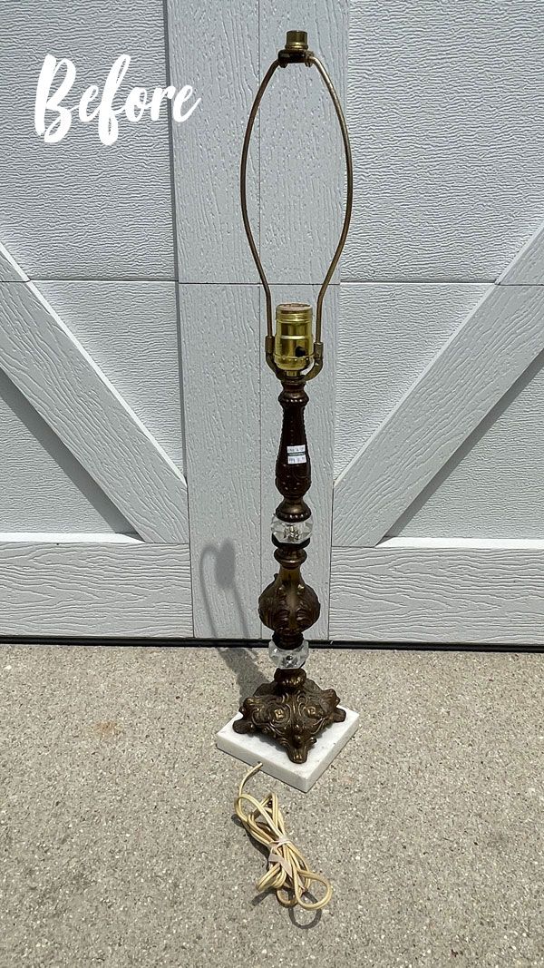 an old fashioned lamp sitting in front of a garage door with the word before written on it