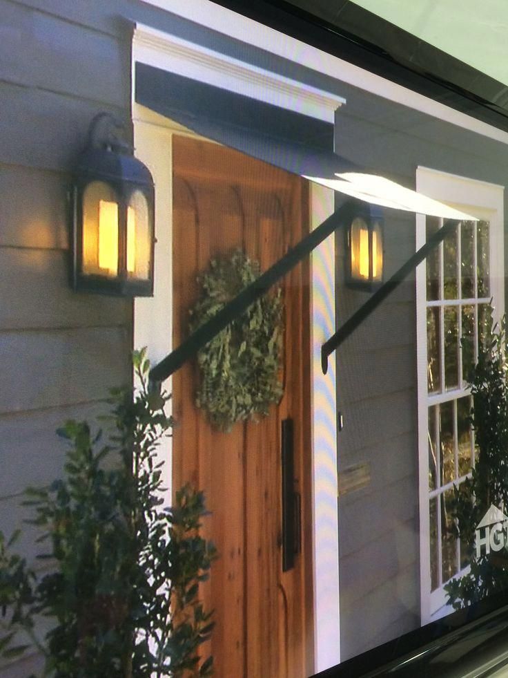 the front door of a house is decorated with wreaths and lights