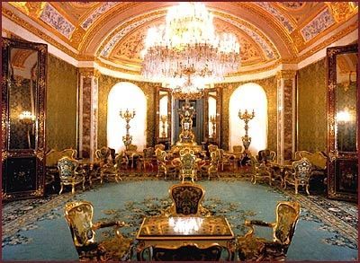 an ornately decorated room with chandeliers and chairs in it's center