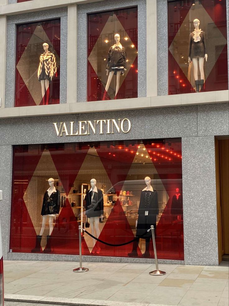 a store front with mannequins in the window