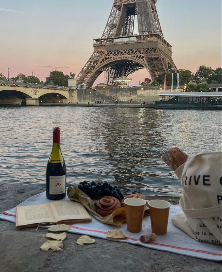 the eiffel tower is in the background with food and drinks on it