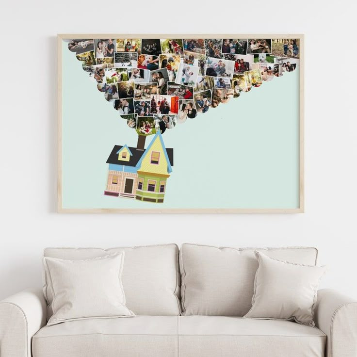 a living room with a couch and a wall hanging above it that has pictures on it