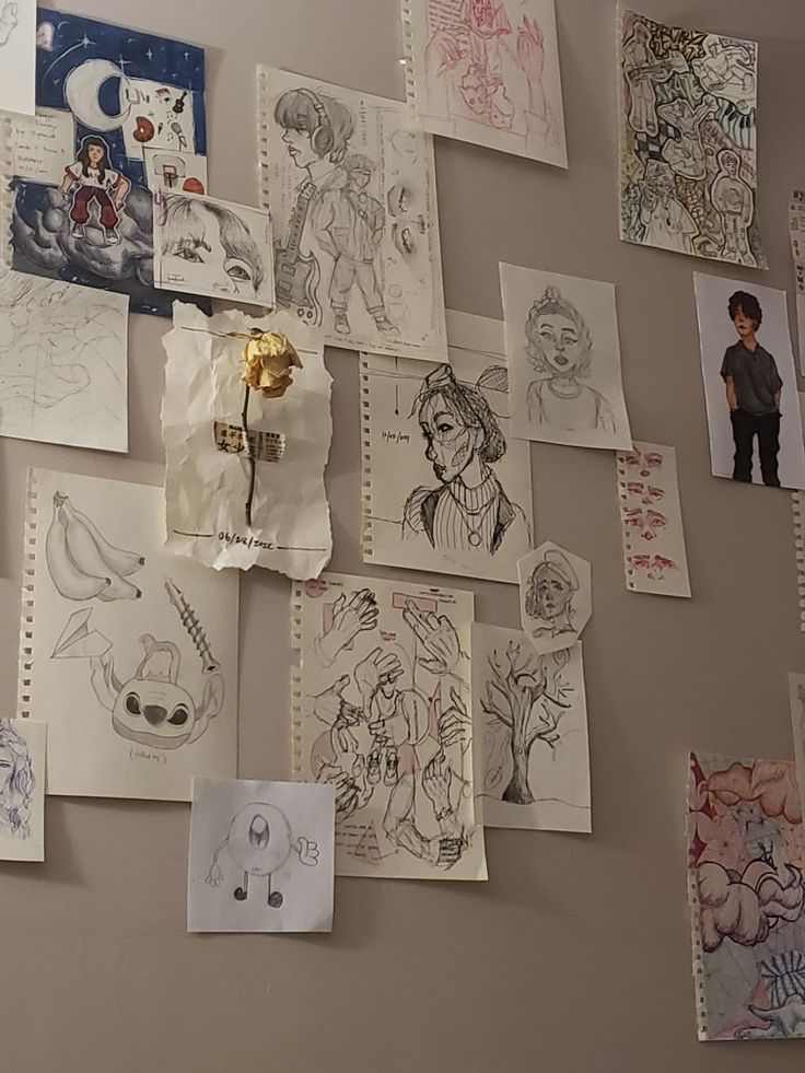 many drawings are hanging on the wall