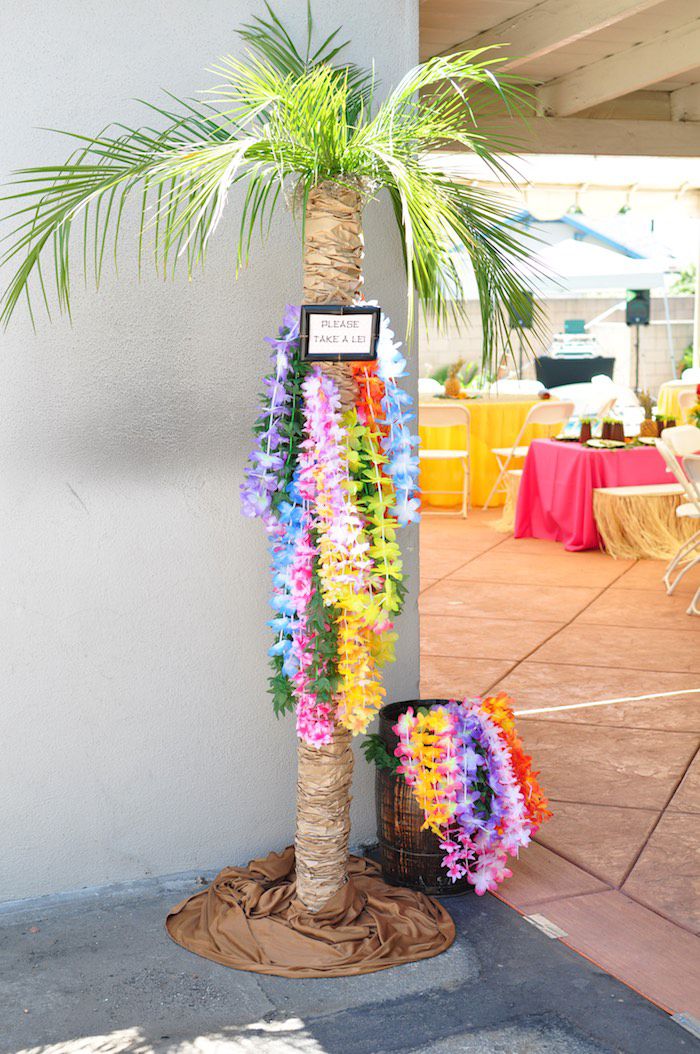 a palm tree decorated with leis and flowers