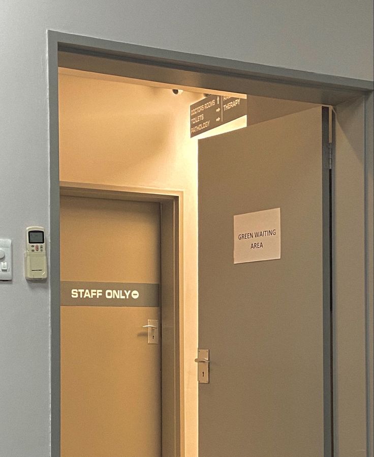 an open door with a sign on it that says staff only