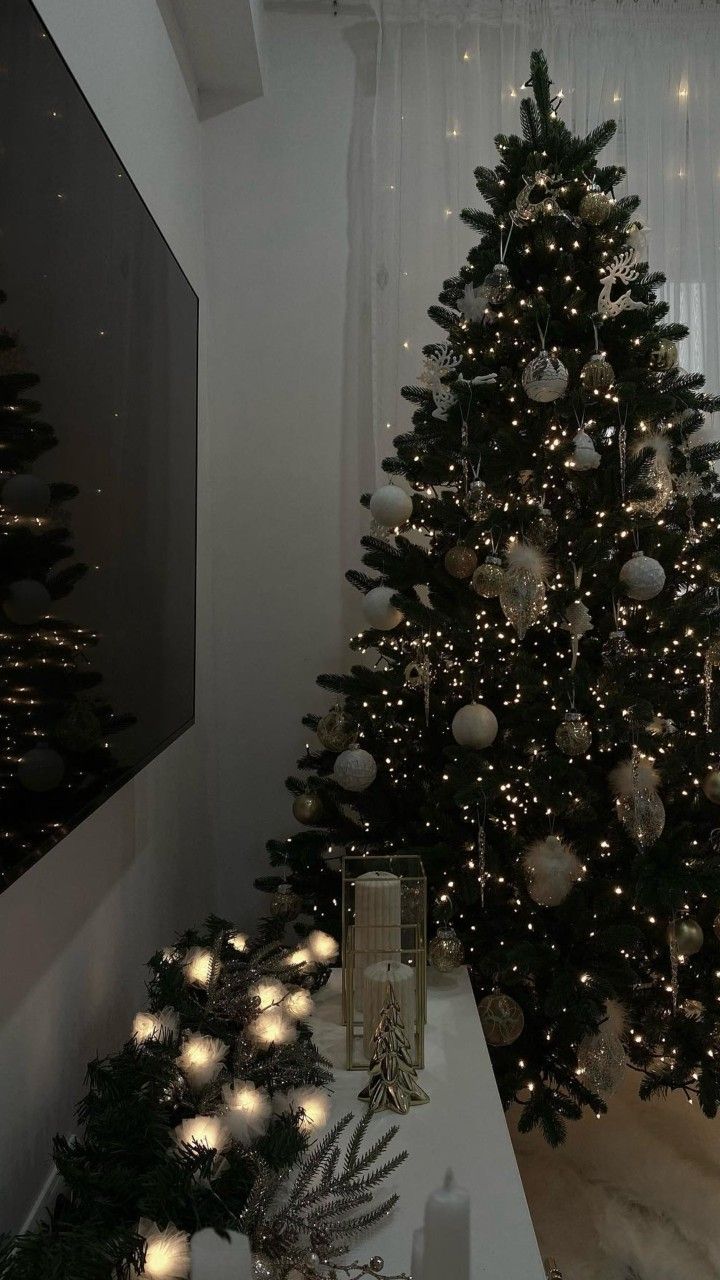 a decorated christmas tree in the corner of a room