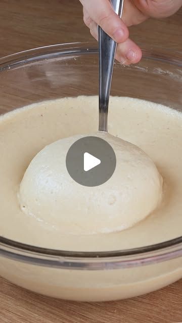 a person mixing batter in a bowl with a spoon