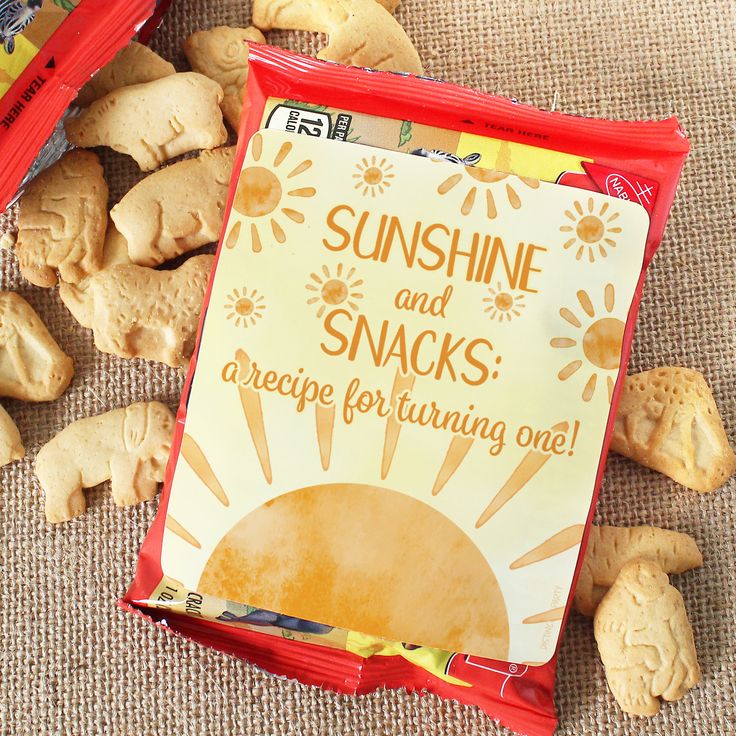 a bag of sunshine and snacks next to some cookies