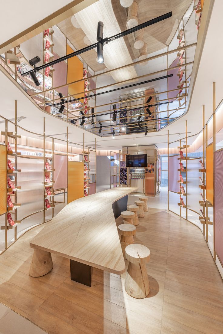 the inside of a shoe store with lots of shelves and stools