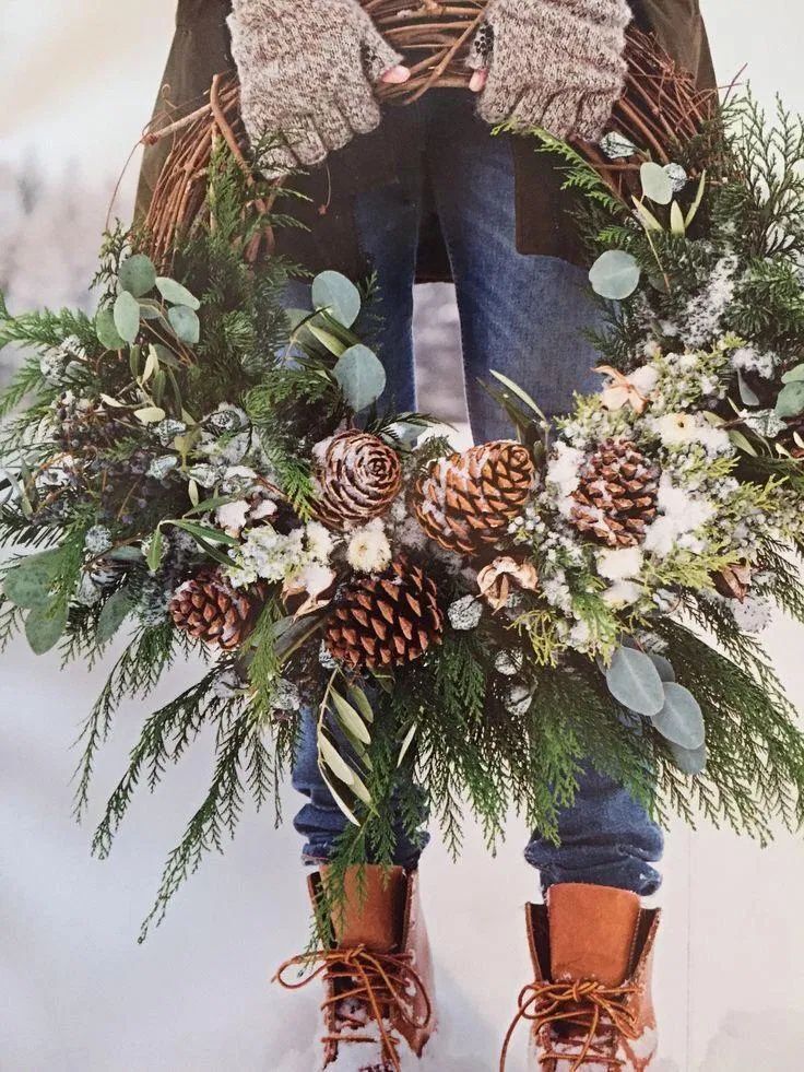 a magazine cover with an image of a person wearing boots and holding a christmas wreath