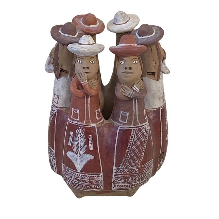 two ceramic figurines with hats on their heads