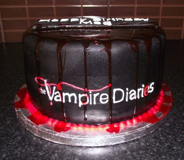 the cake is decorated with chocolate icing and blood dripping down it's sides