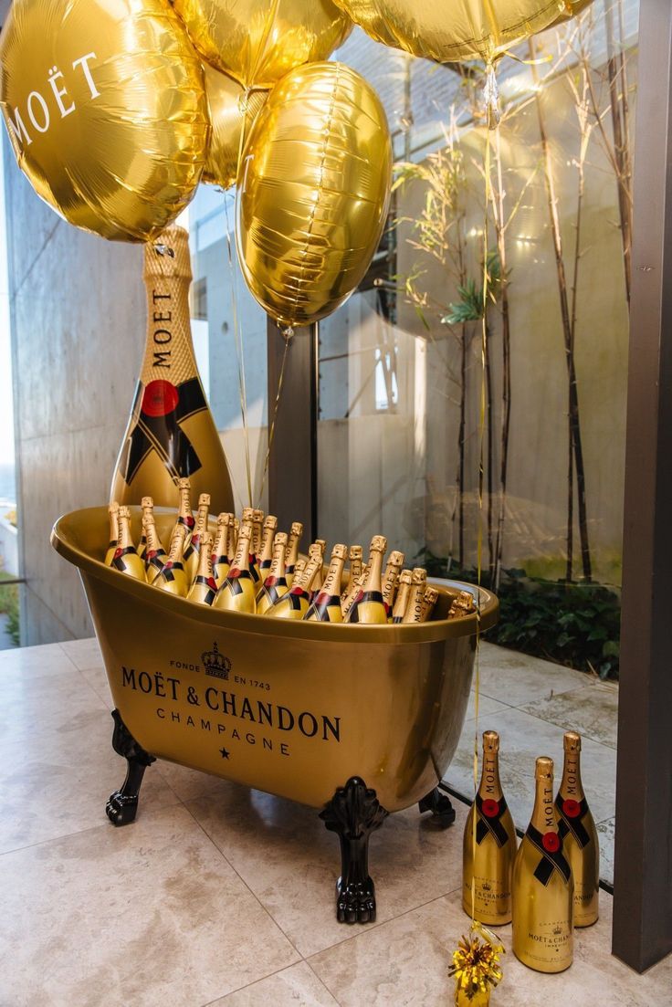 champagne bottles and balloons in a bathtub for a new year's eve celebration