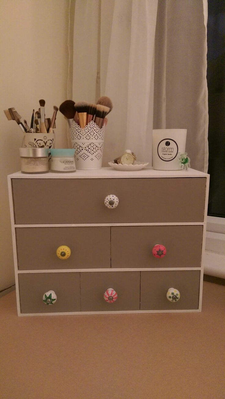 a dresser with several drawers and knobs on it