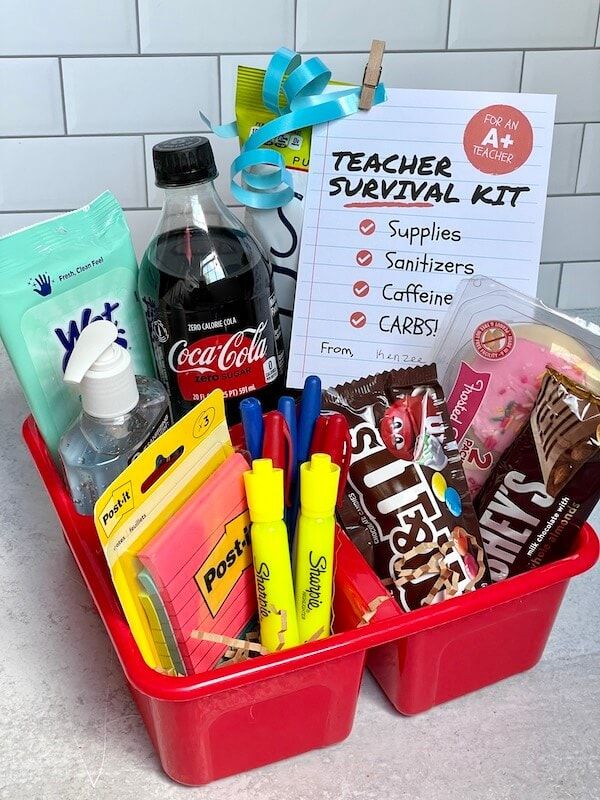 the teacher survival kit is in a red container with markers, pens and other school supplies