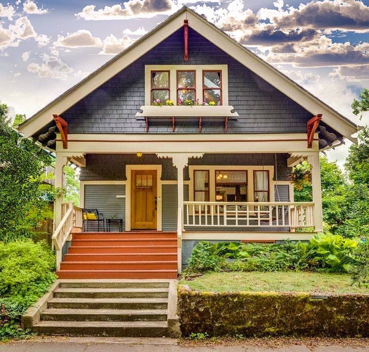 a small house with stairs leading to the front door