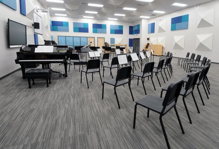 an empty room with chairs and piano in it