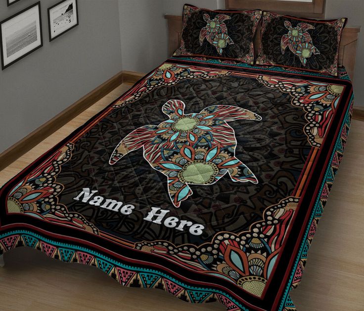 a bed with a turtle on it and name here written on the comforter cover