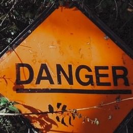 an orange sign that says danger on it