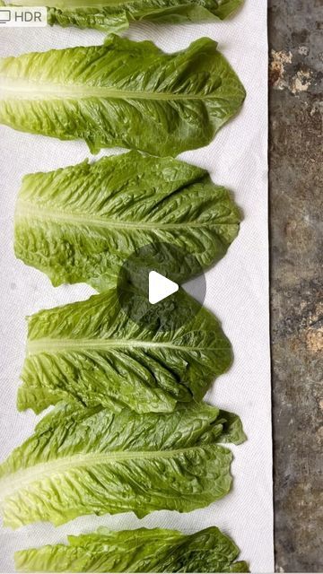 lettuce leaves on a white paper towel with a video player in the middle