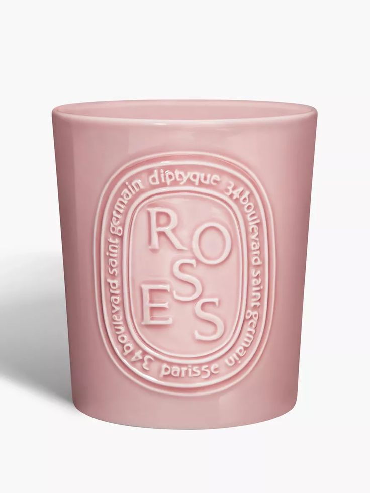 a pink glass cup with the words roses on it and a white logo in the middle